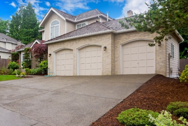 A three car, custom built garage attached to a large home